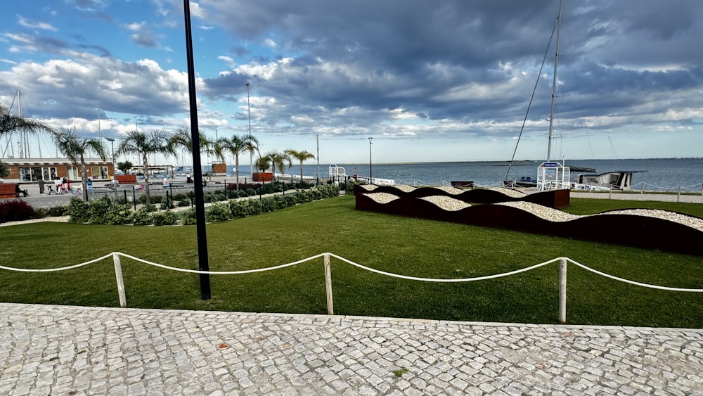 a grassy area next to a body of water