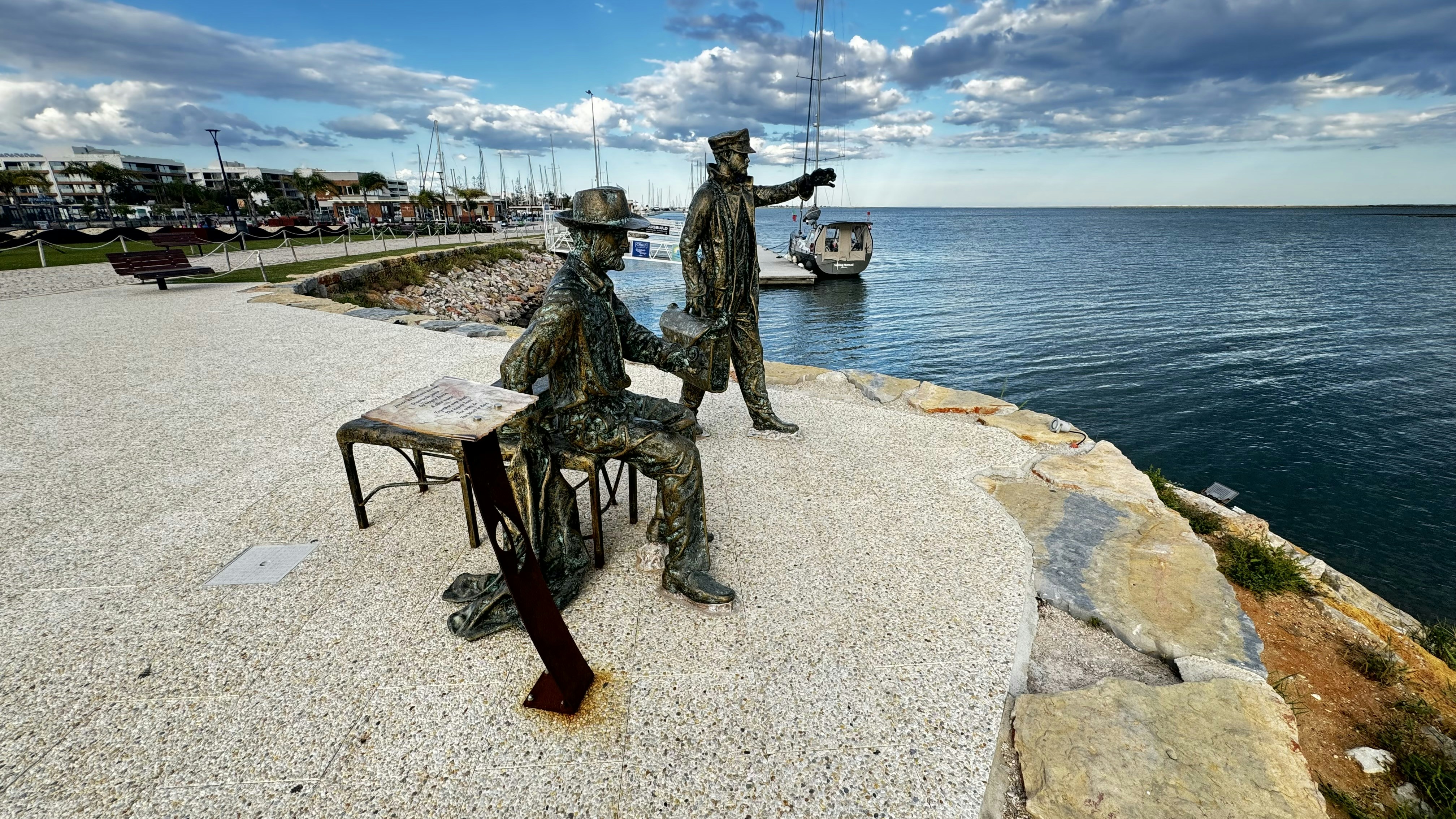 a couple of statues sitting on top of a bench