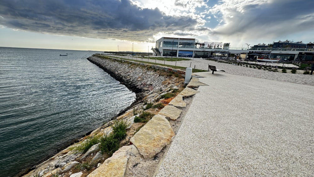 a person sitting on a bench next to the ocean