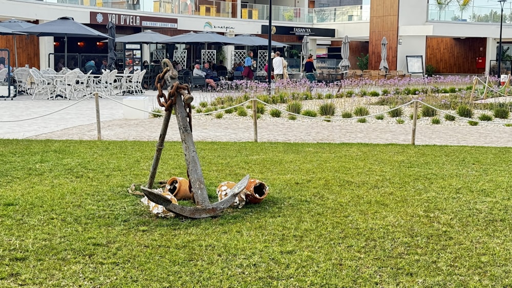 a sculpture of an anchor in the middle of a grassy area