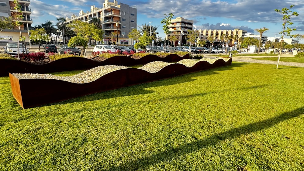 a grassy field with a sculpture in the middle of it