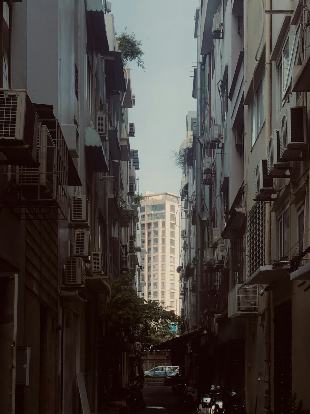 a narrow city street lined with tall buildings