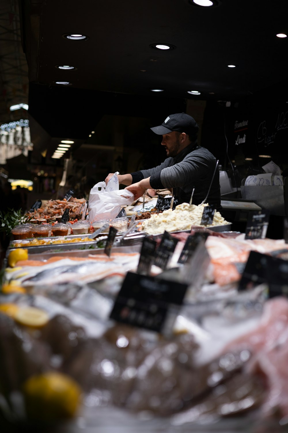 a man standing at a table with a bag of food