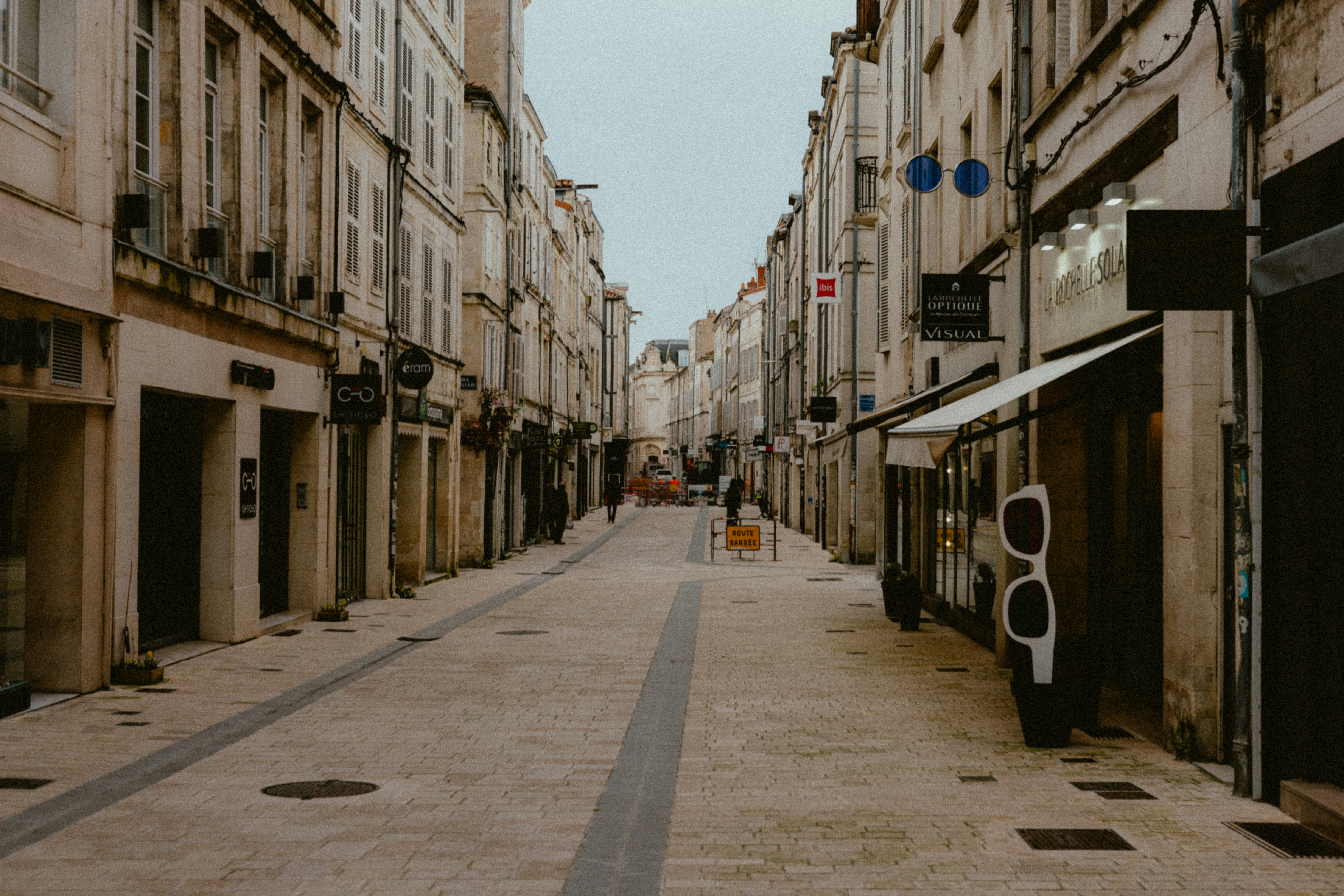 a narrow city street lined with tall buildings