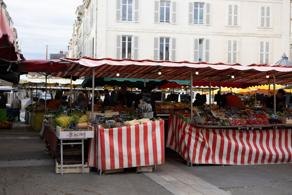 an outdoor market with a variety of fruits and vegetables