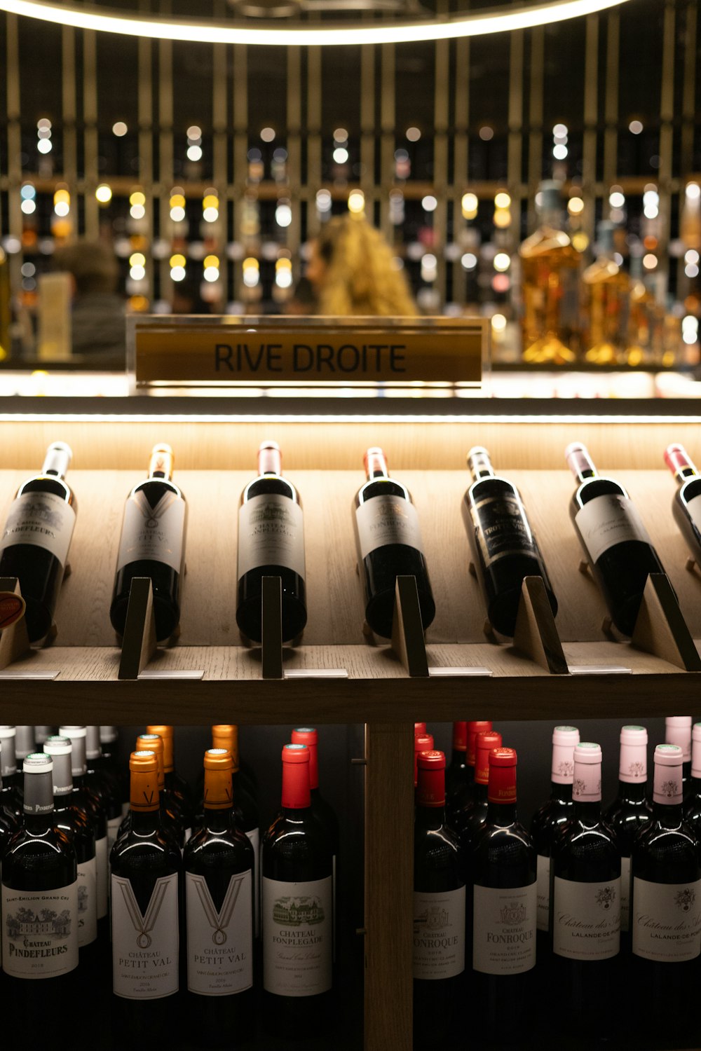 bottles of wine are lined up on a shelf