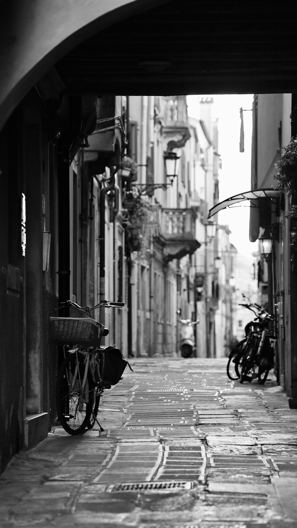 a black and white photo of a narrow street