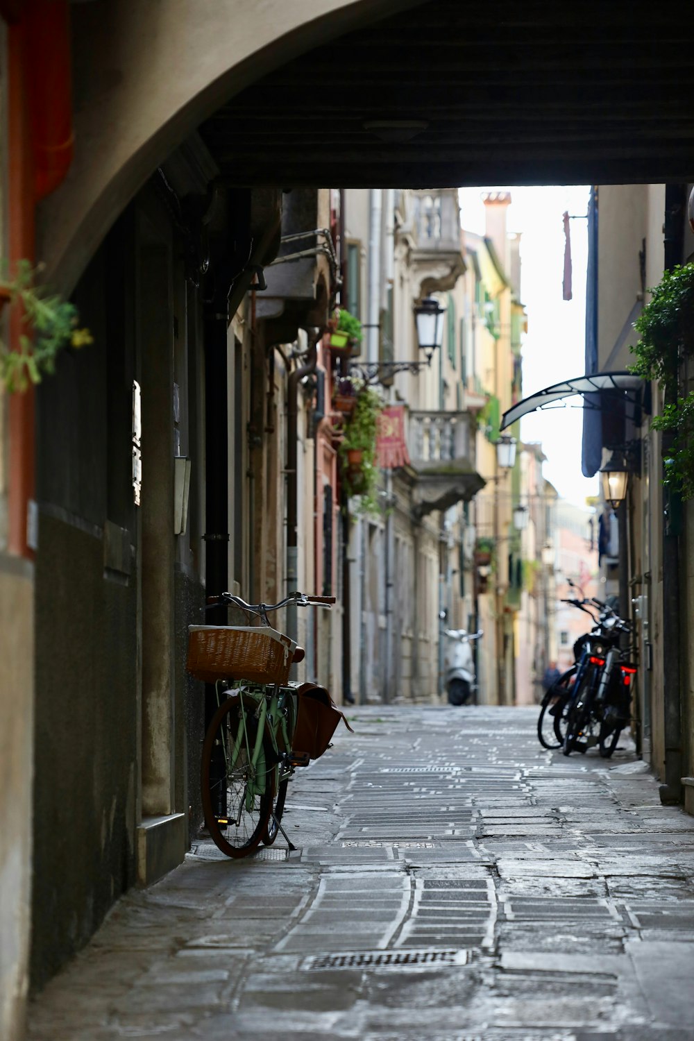 a bike parked on the side of a narrow street