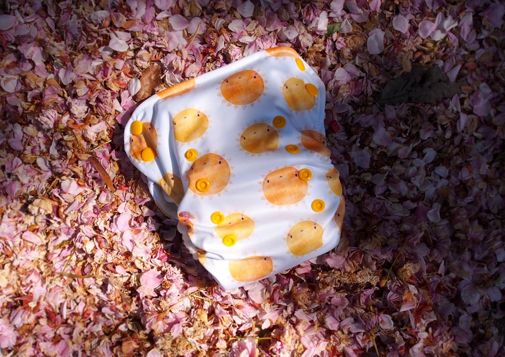 a cloth diaper is laying on a bed of flowers