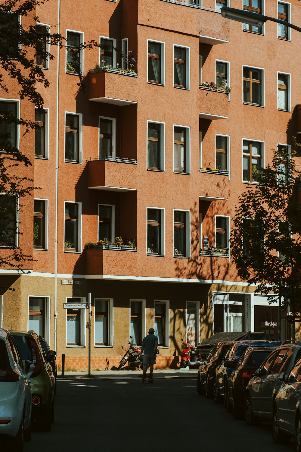 a man riding a bike down a street next to tall buildings