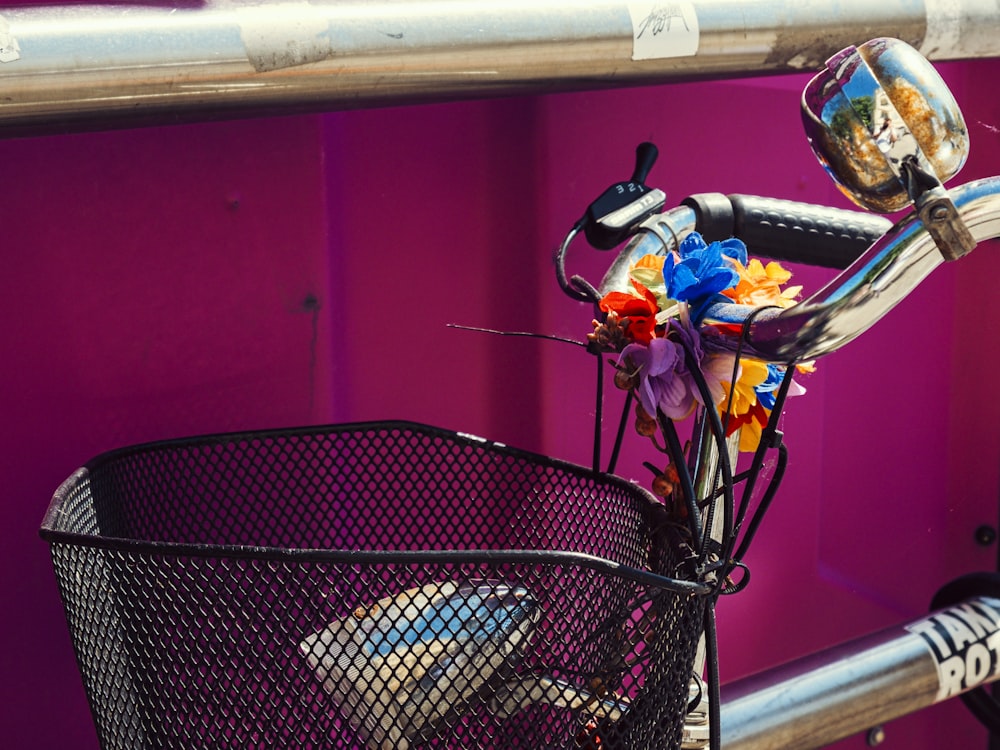 a bicycle parked next to a purple wall