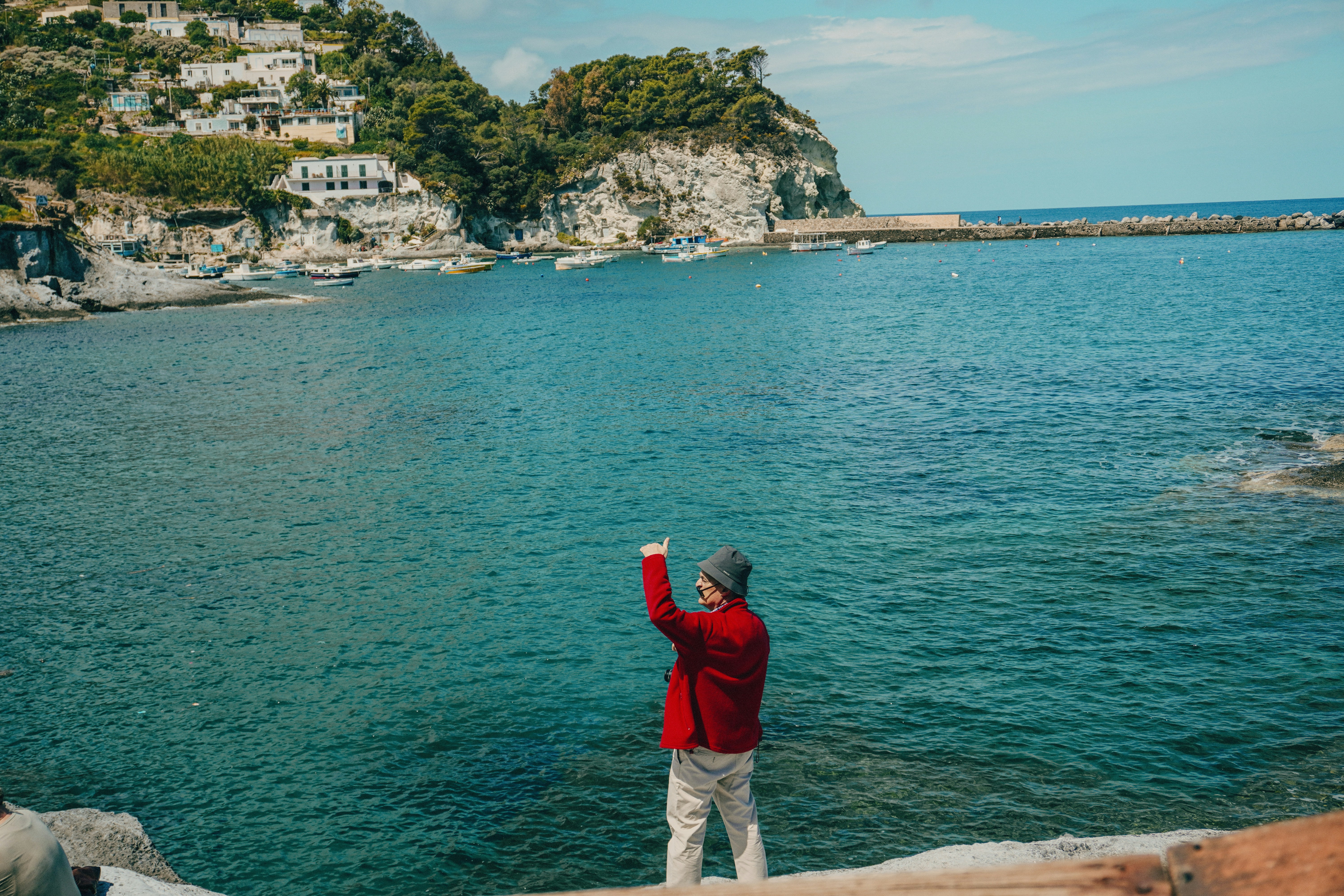 a man standing on a cliff overlooking a body of water