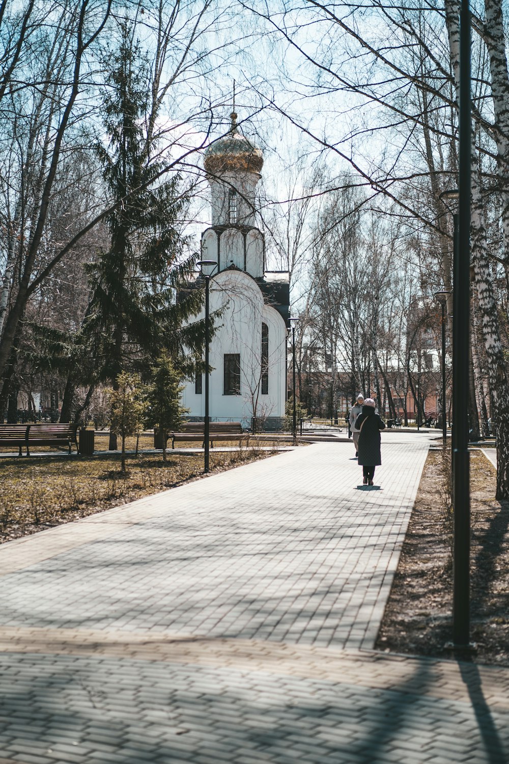 a person walking down a path in a park