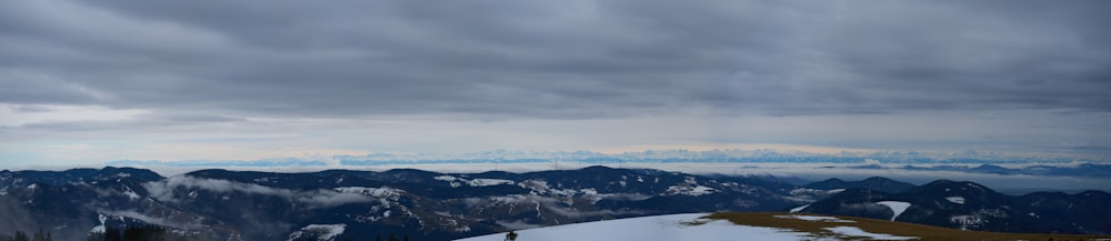 a snowboarder is standing on top of a snowy mountain