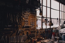 a man sitting in a chair in a room filled with tools