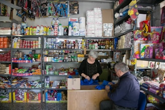 a man and a woman sitting at a counter in a store