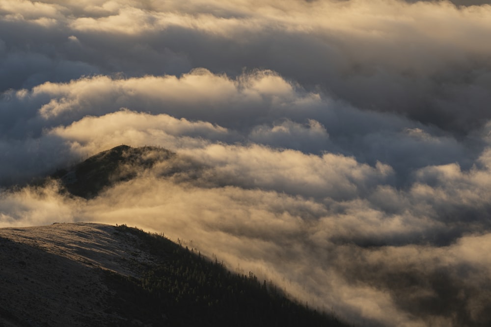 a view of a mountain covered in clouds