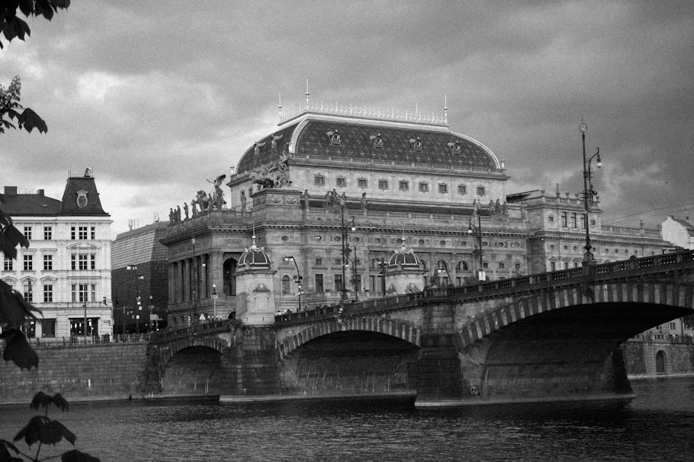 a black and white photo of a bridge over a river