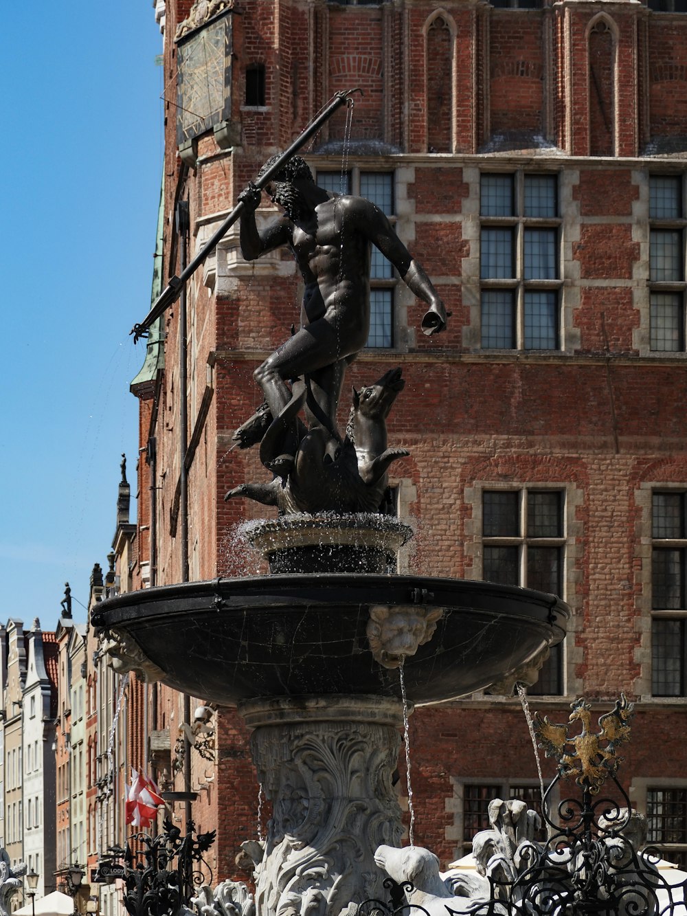 a fountain with a statue of a man holding a sword