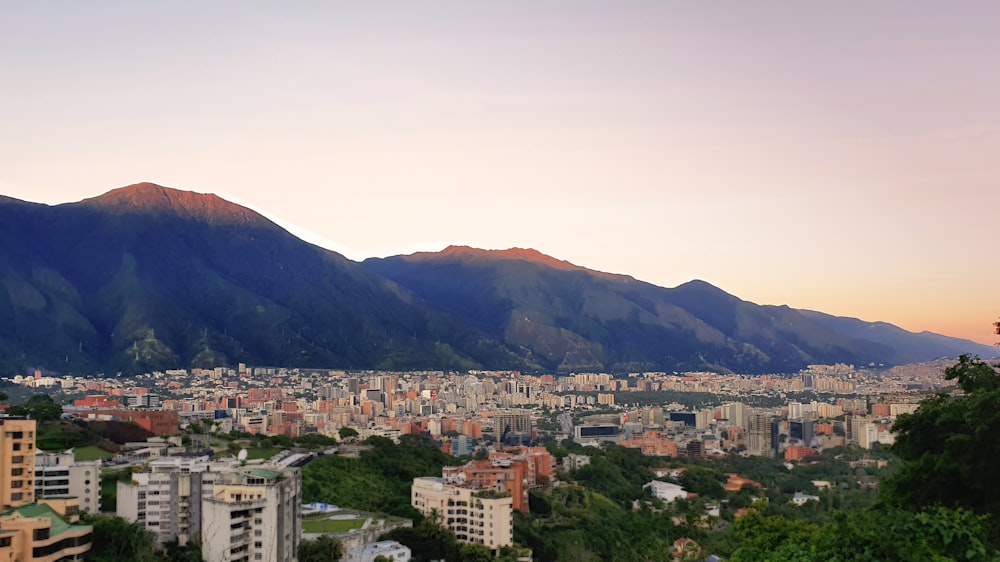 a view of a city with mountains in the background