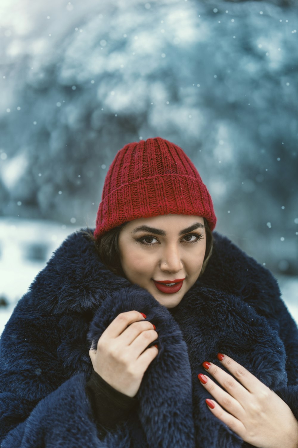 a woman wearing a red hat and a blue coat