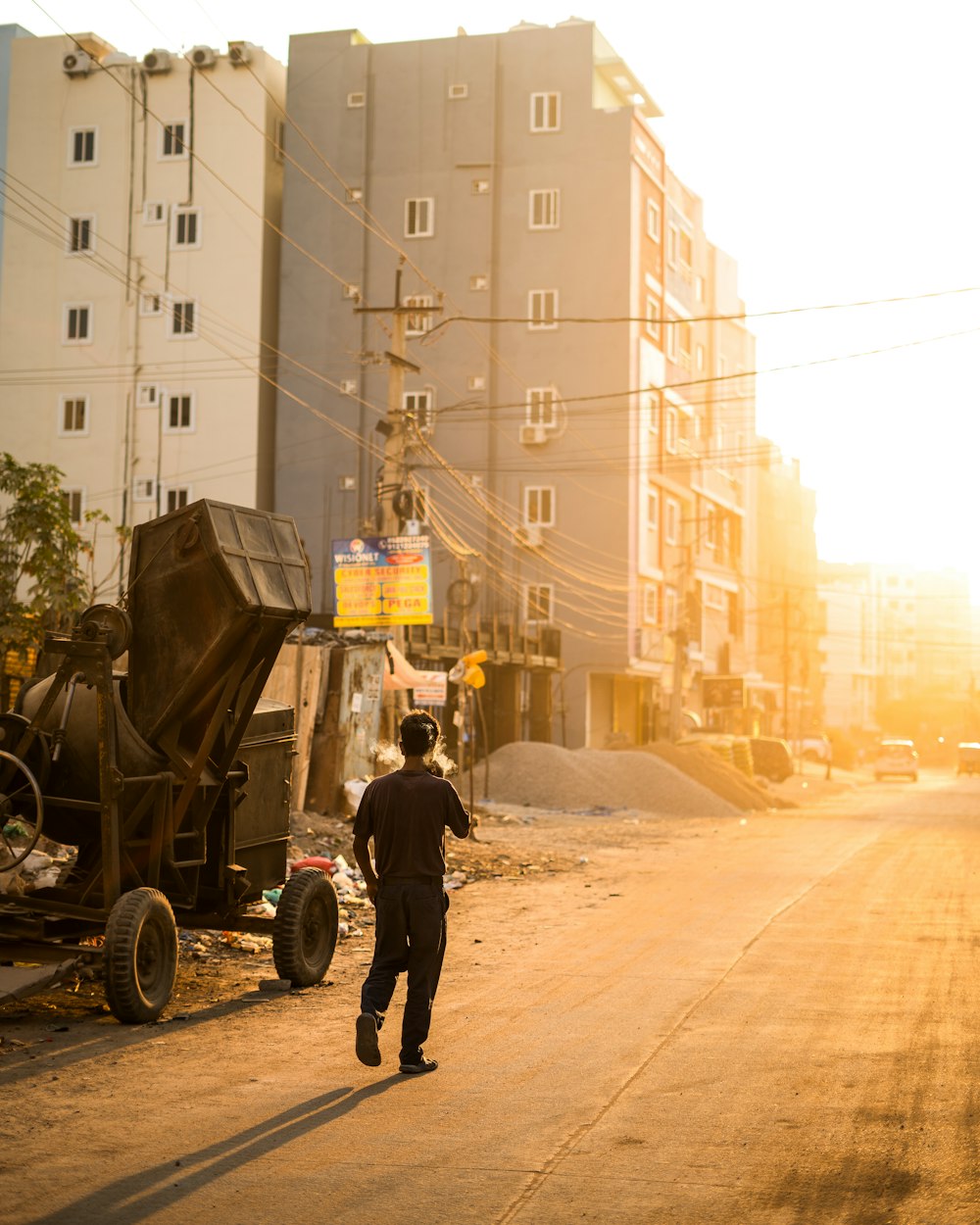 a man walking down a street next to a dump truck