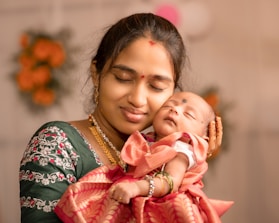 a woman holding a baby in her arms