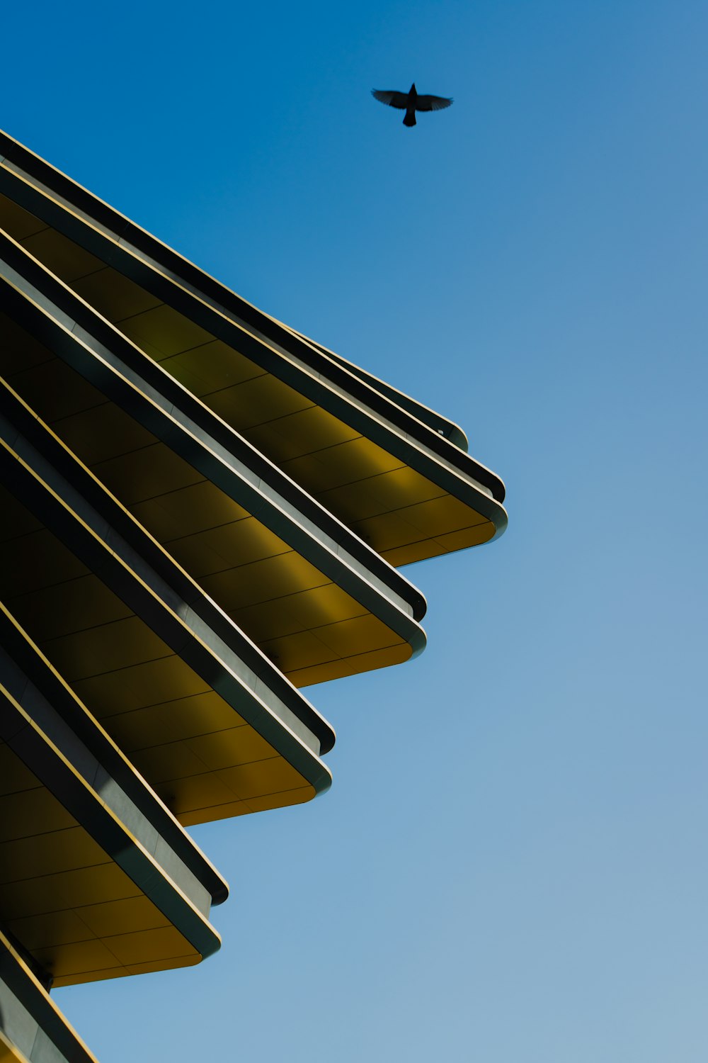 a plane flying in the sky over a building