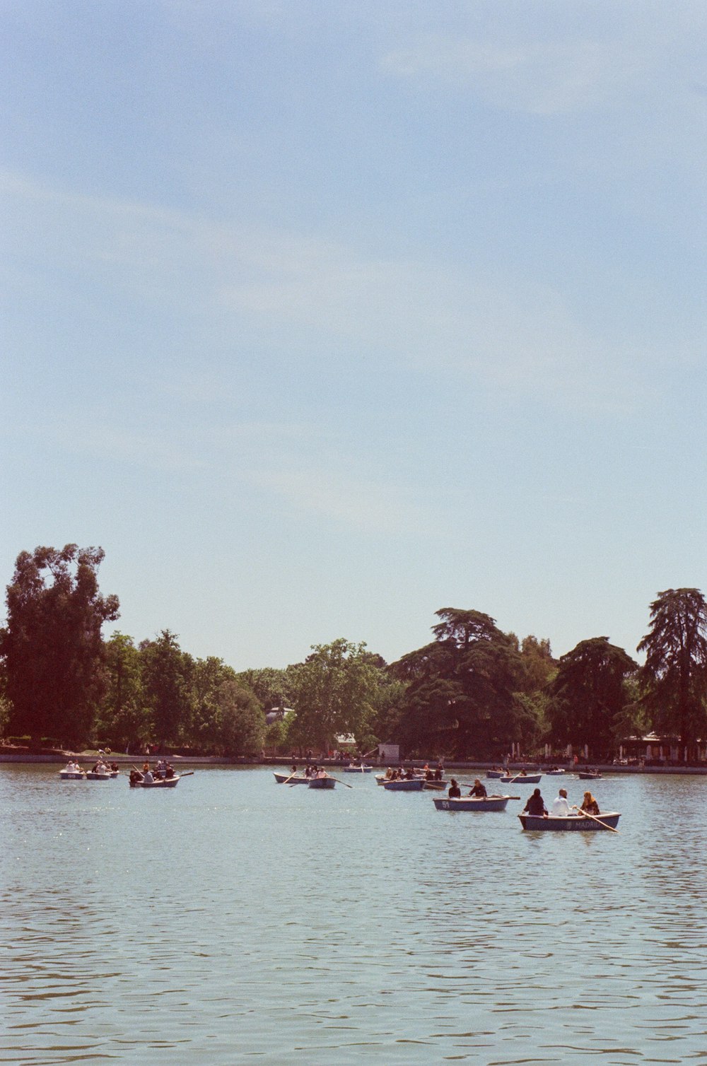 a group of people in small boats on a lake