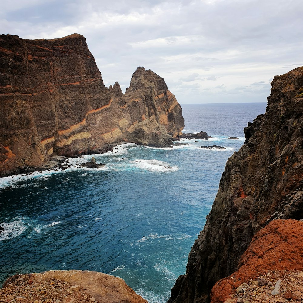 a view of the ocean from a rocky cliff