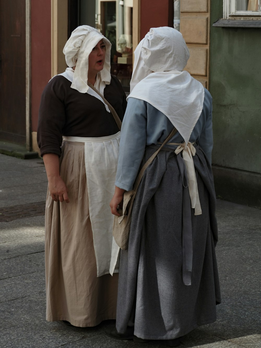 a couple of women standing next to each other on a street