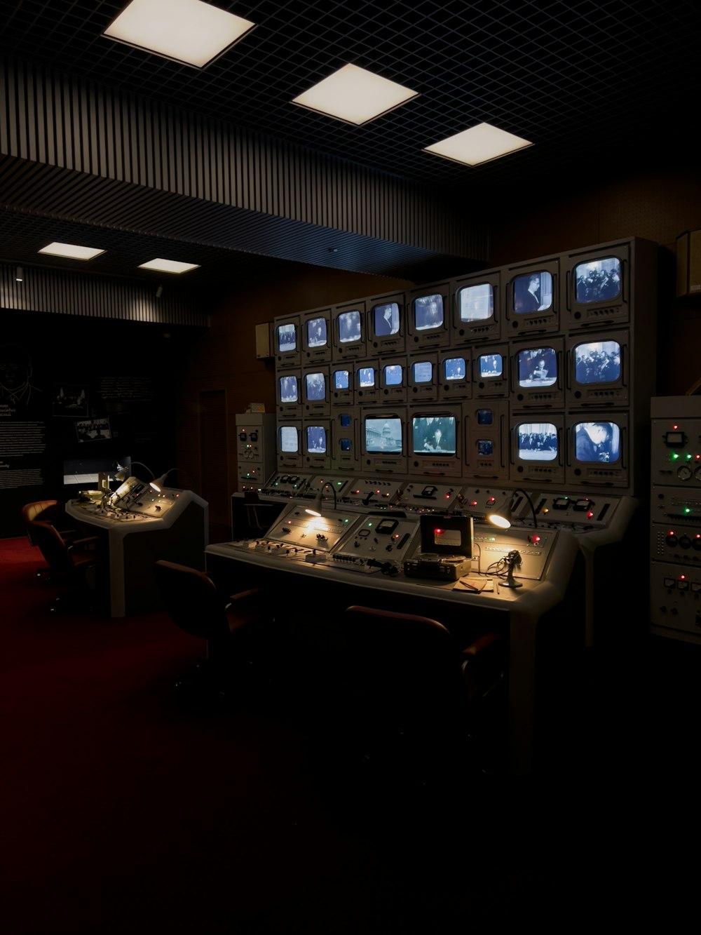 a control room with multiple monitors and lights