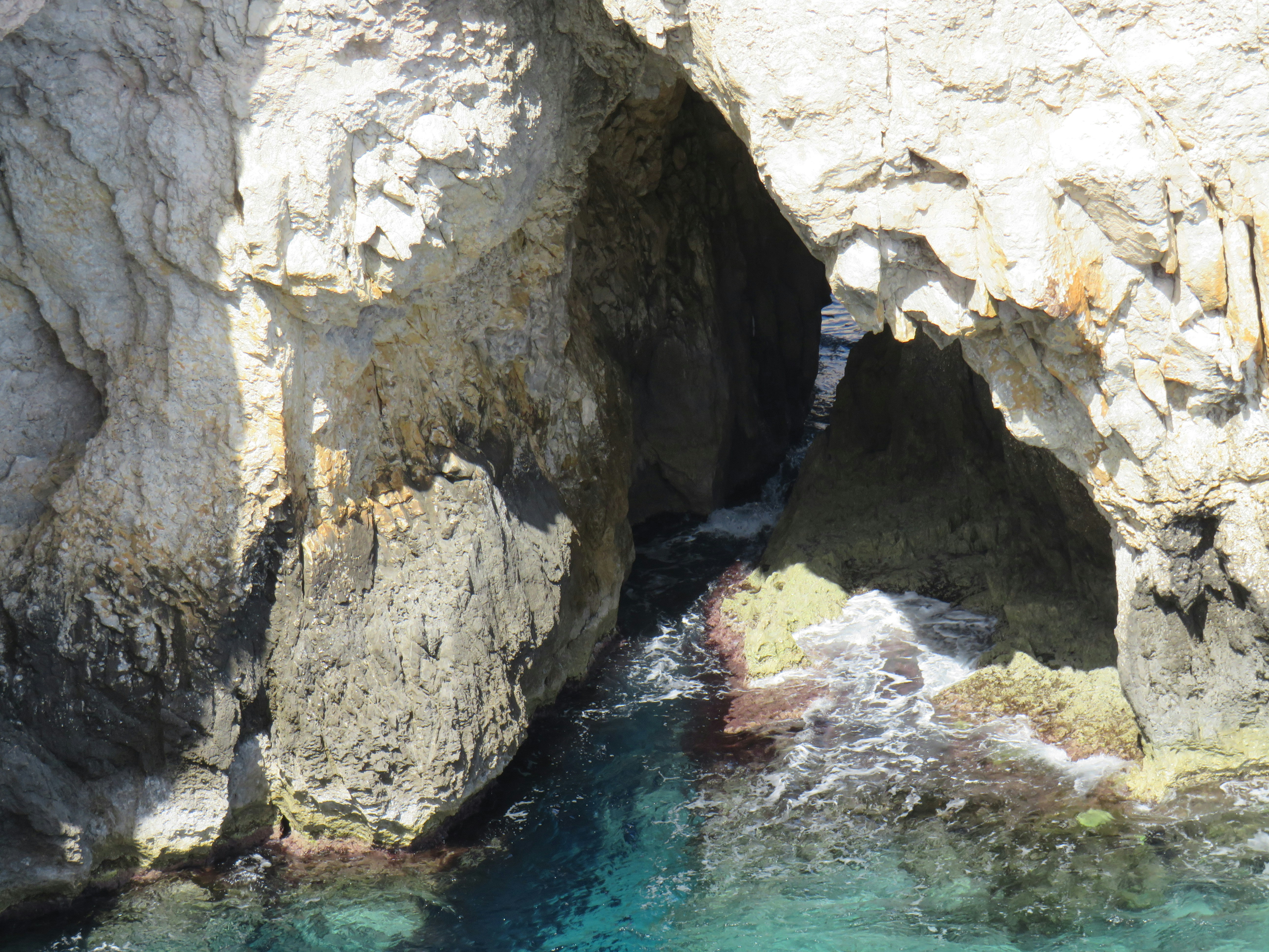 a body of water in between two large rocks, 