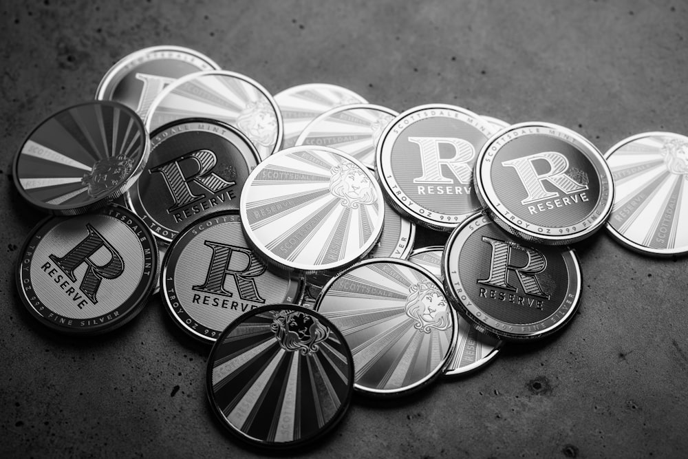 a pile of metal badges sitting on top of a floor