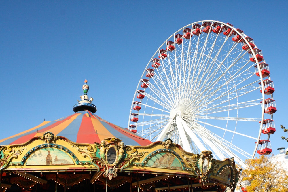 a carnival ride with a ferris wheel in the background