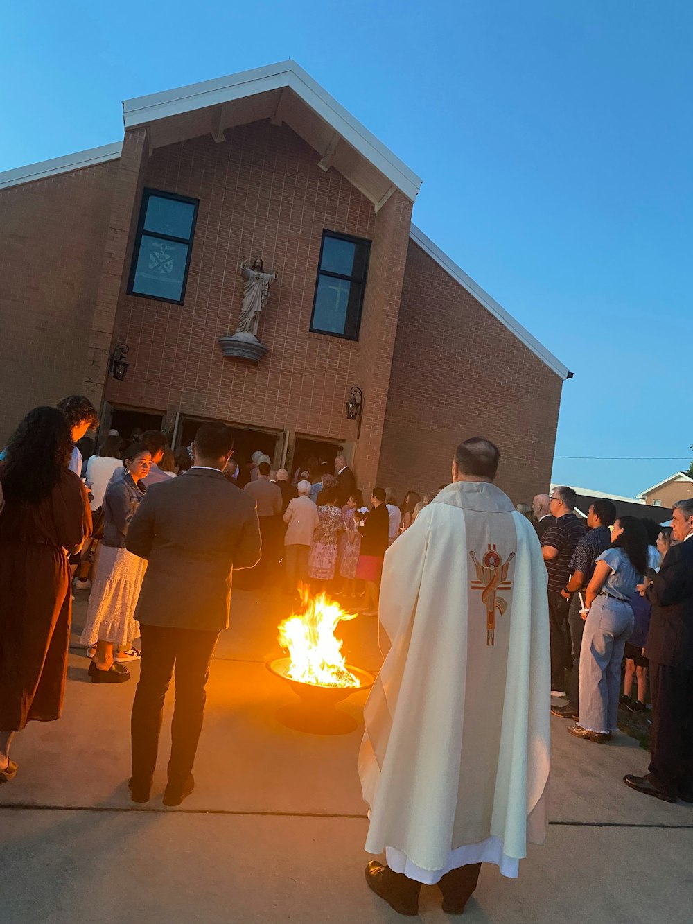 a group of people standing around a fire pit