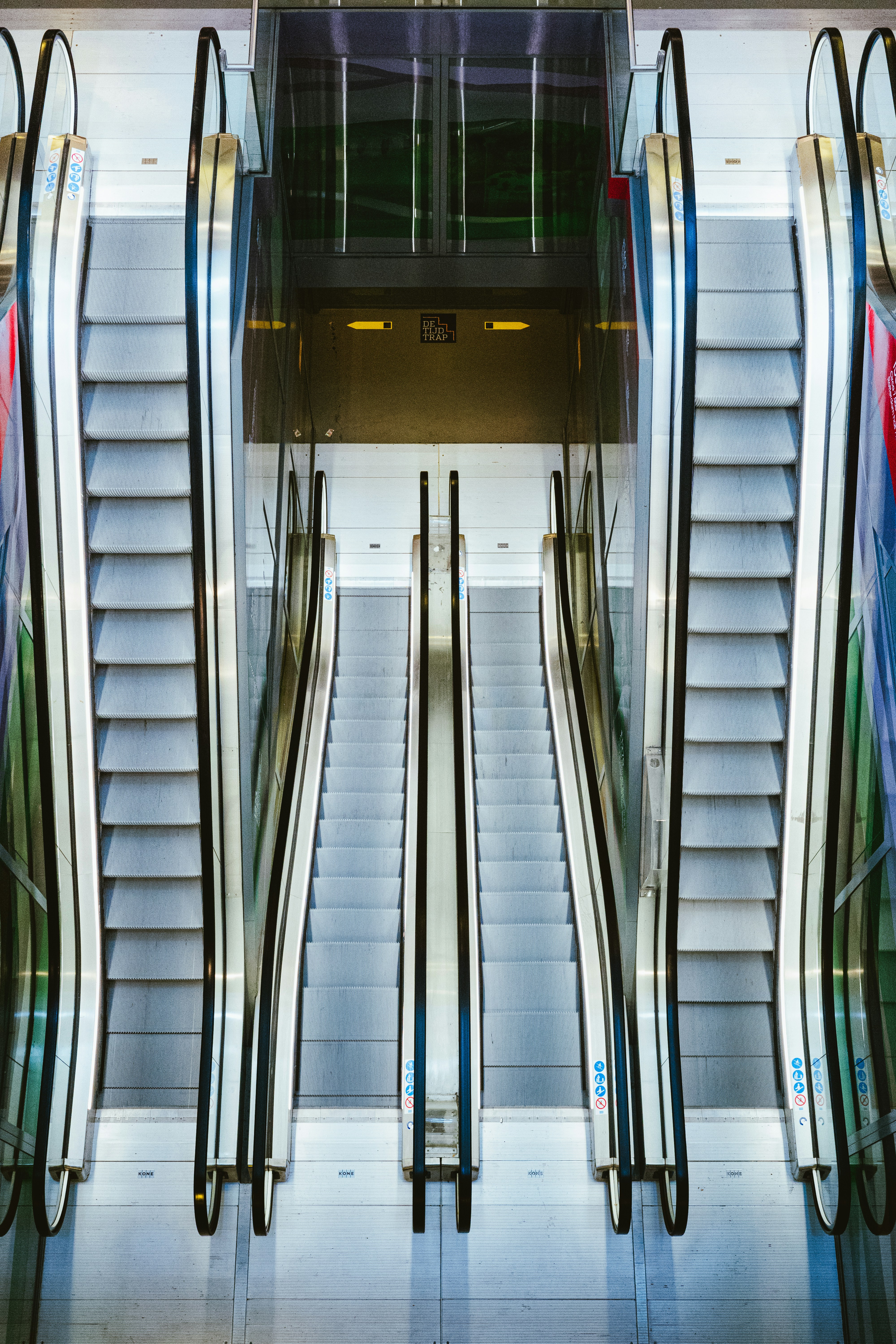 Escalators face each other in a modern building.