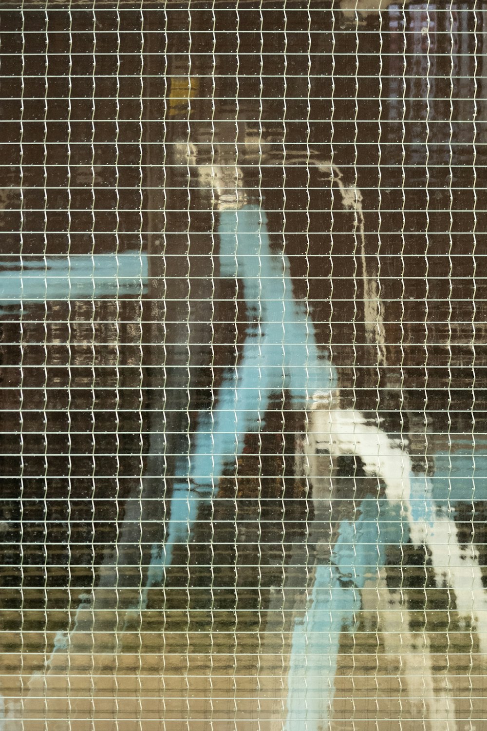 a close up of a window with a blue pipe