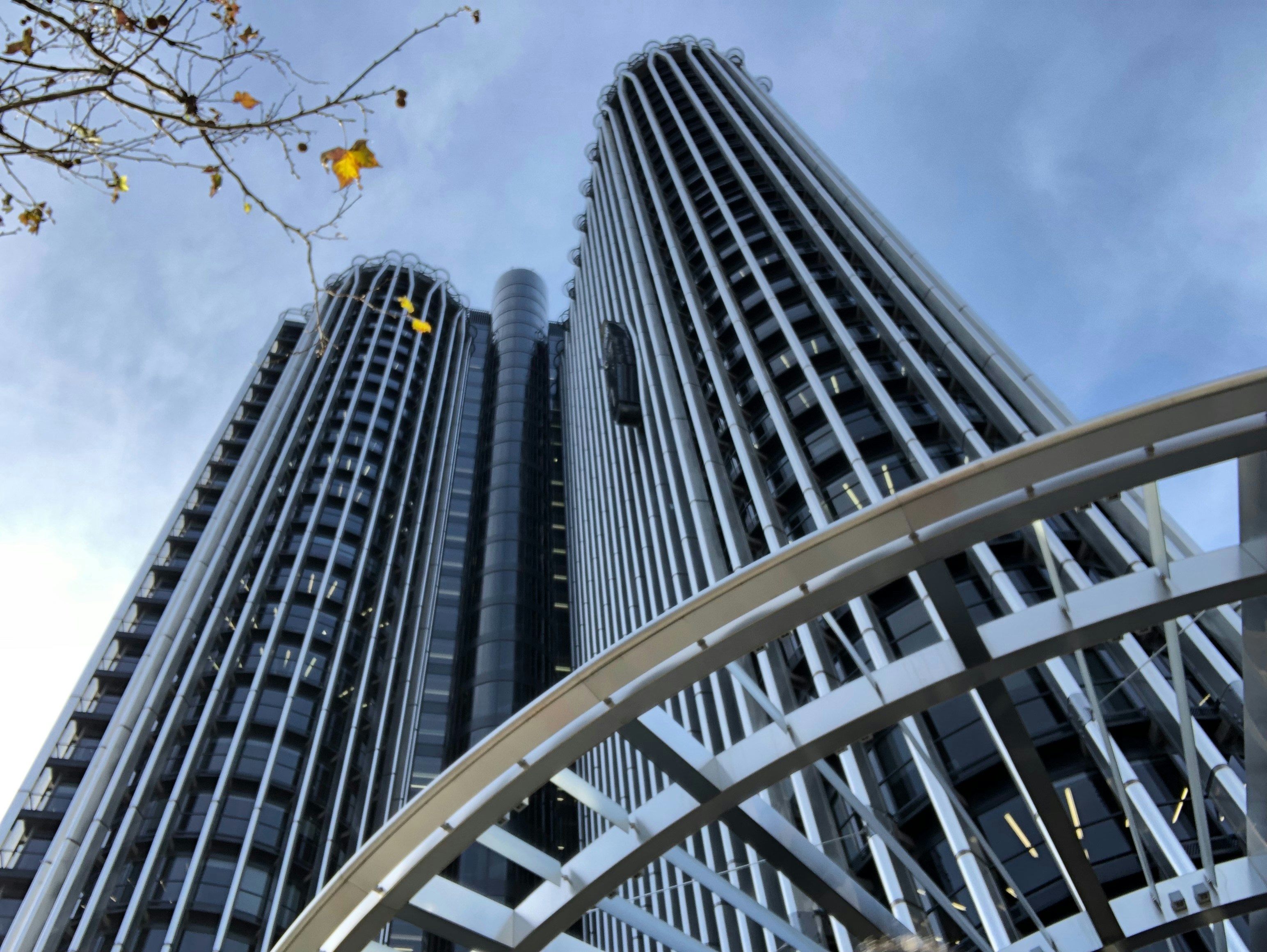 a tall building with a circular walkway in front of it
