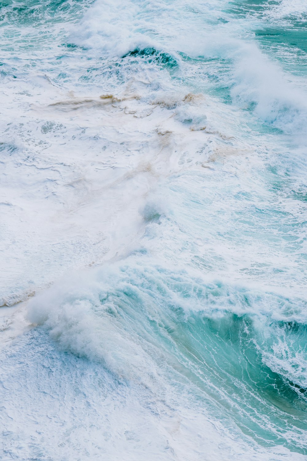 a person riding a surfboard on a wave in the ocean