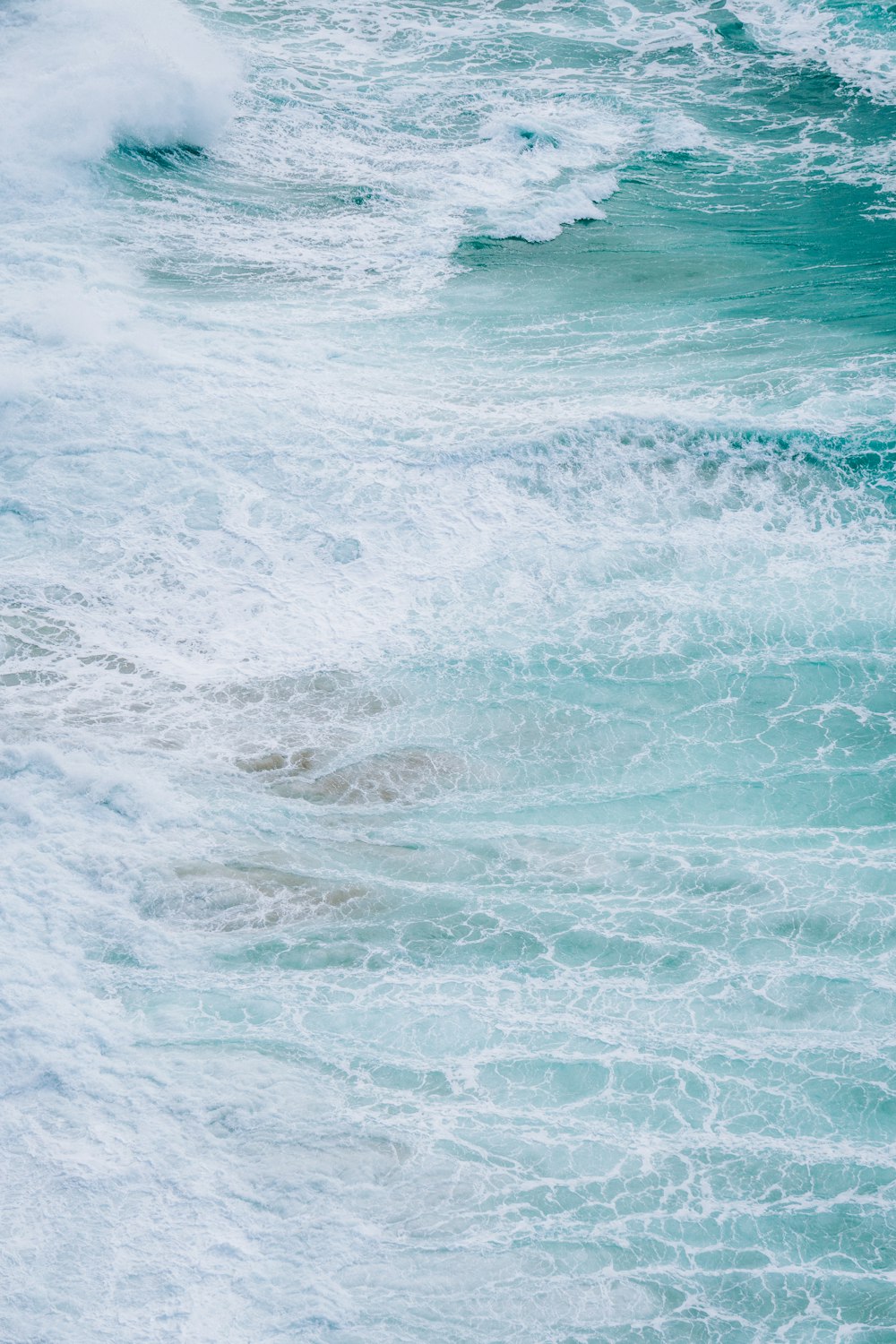 a man riding a surfboard on top of a wave in the ocean