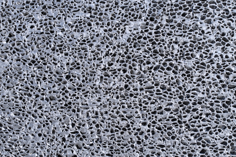 a close up of a cement surface with water drops