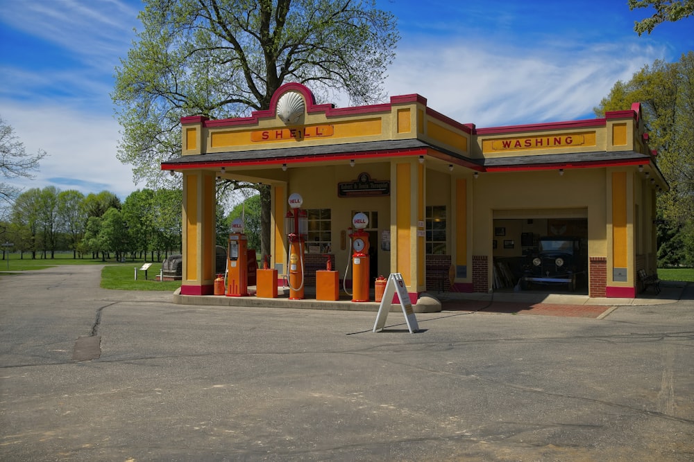 a yellow gas station with a blue sky in the background