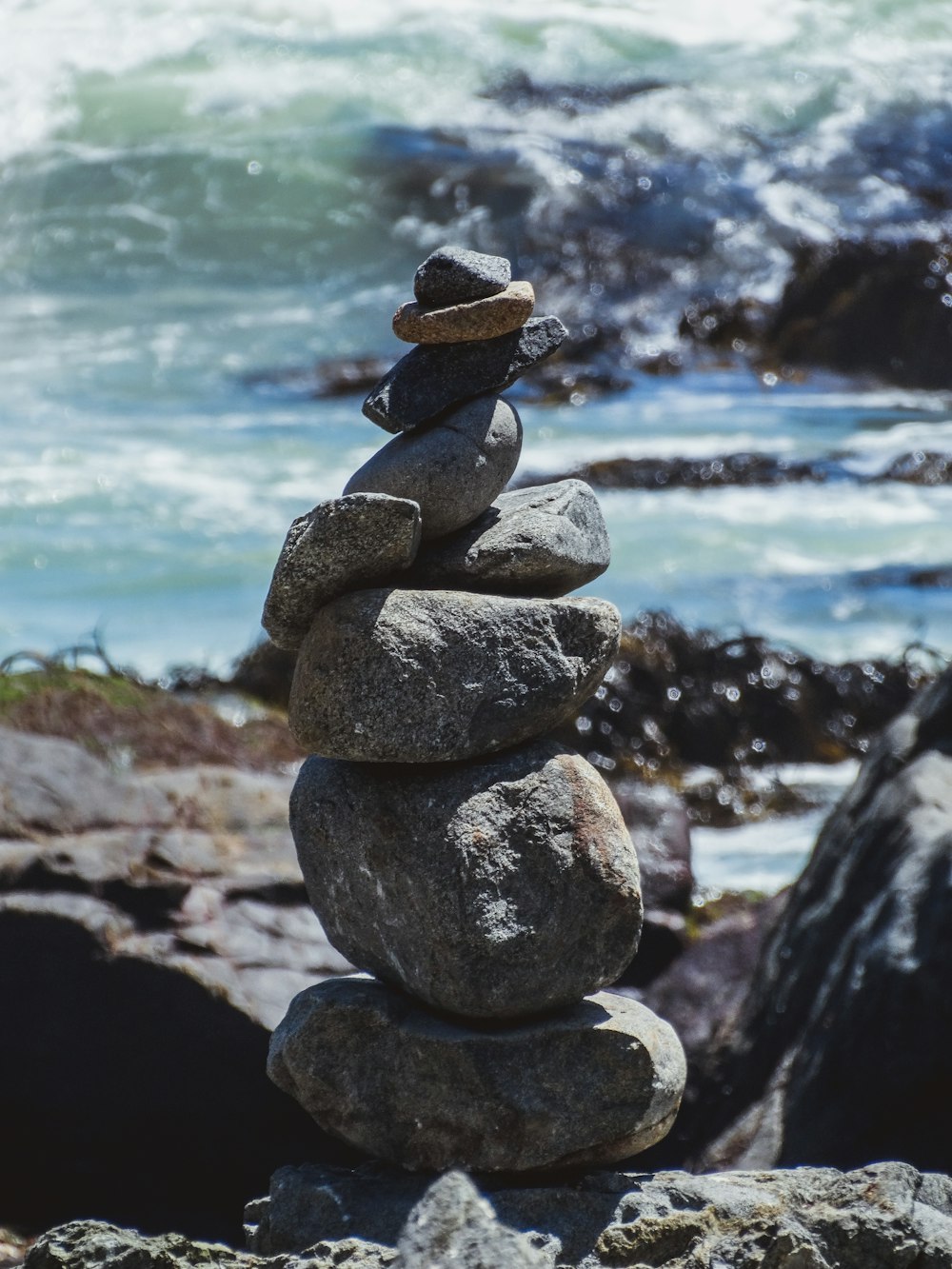 a stack of rocks sitting on top of a rocky beach