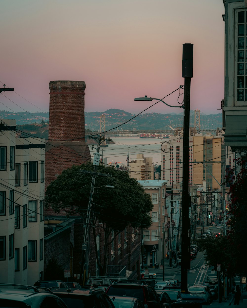 a view of a city at sunset from a hill