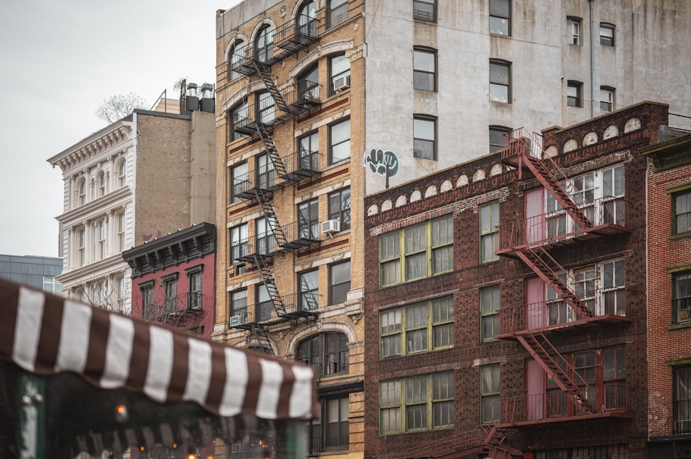 a group of buildings with fire escapes on the top of them