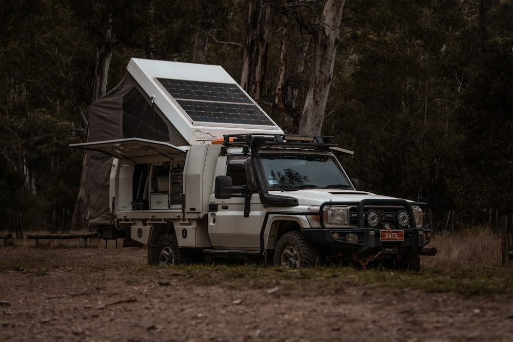 a white truck with a solar panel on top of it