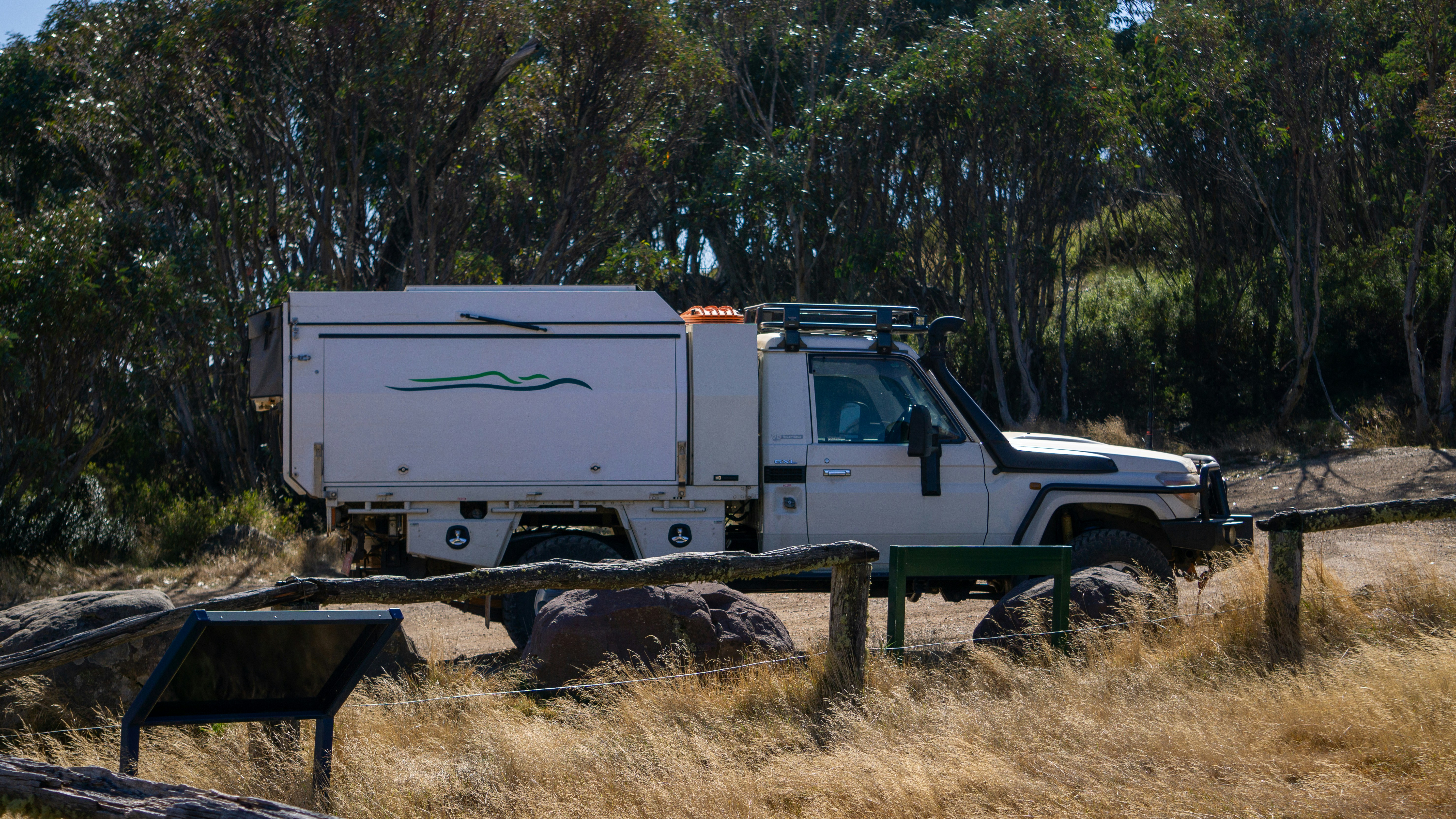 Electric pickup truck towing a camping trailer on a highway