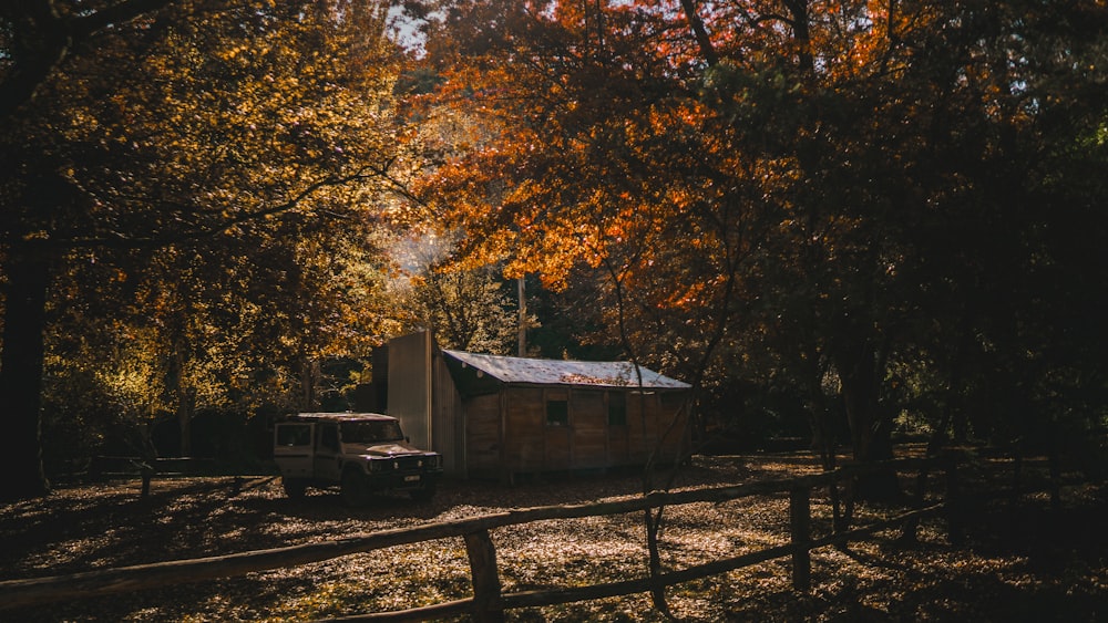 a truck parked in front of a small cabin