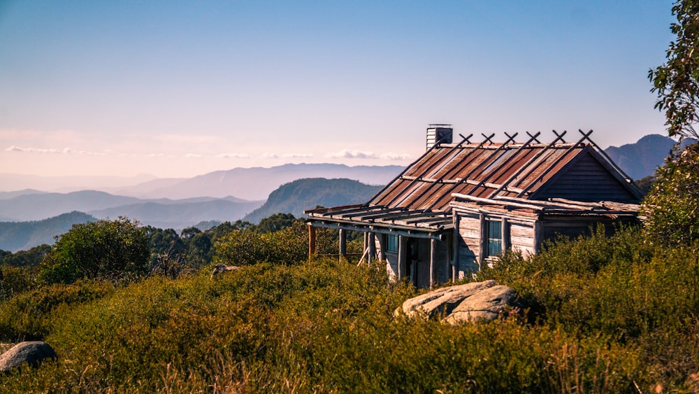 a small house sitting on top of a lush green hillside